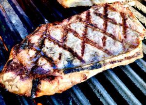 Strip Steak Bone In on the grill