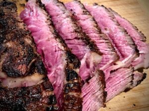 Sliced Ribeye grilled medium rare on cutting board