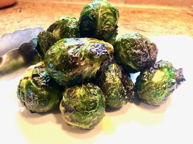 Grilled Brussel Sprouts sitting on a plate