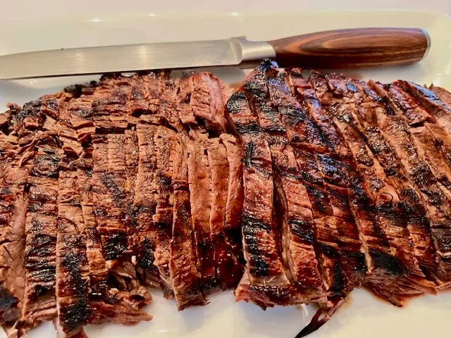 Asian Flank Steak plated with carving knife