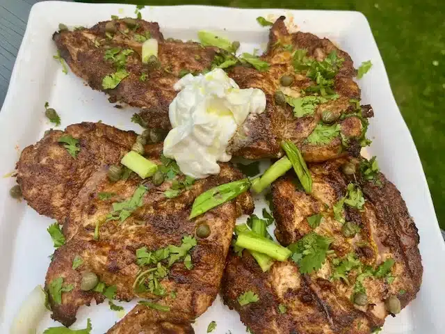 Grilled Chicken Platter seasoned with Garam Masala topped with cilantro and yogurt.